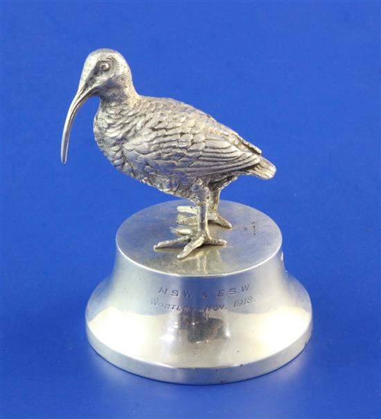 A George V silver paperweight modelled as a curlew on a plinth base, retailed by Asprey, 3.25in.